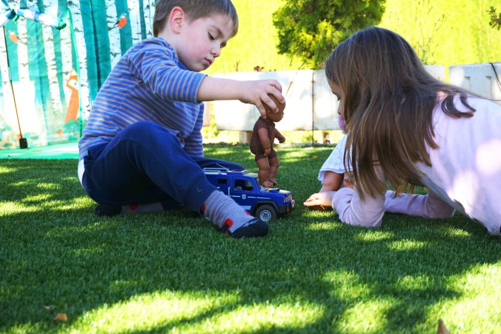 Children playing quietly on the lawn of Albergrass